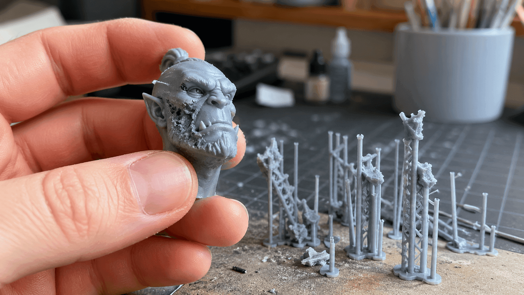 a damaged 3D printed miniature head Removed traditional supports